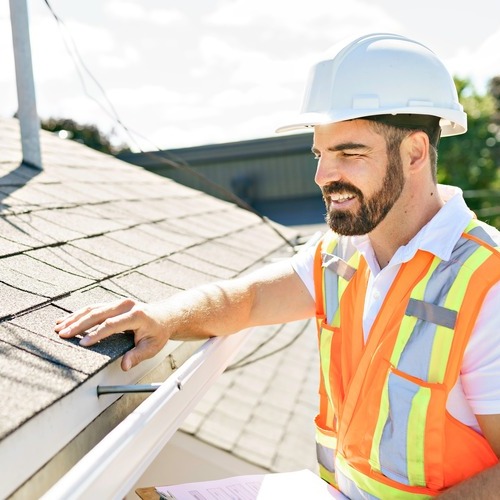 roofer inspecting a roof and gathering evidence to make an insurance claim